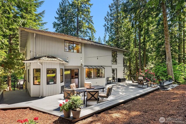 2911 216th Ave NE, Sammamish, WA 98074 - back of house featuring a wooden deck and a fire pit