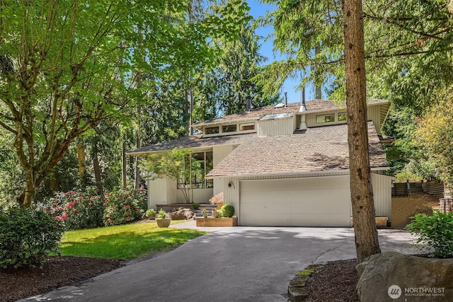 2911 216th Ave NE, Sammamish, WA 98074 - mid-century modern home with asphalt driveway, a front yard, and an attached garage