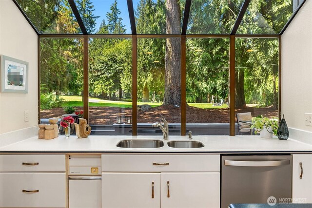 2911 216th Ave NE, Sammamish, WA 98074 - kitchen with stainless steel dishwasher, a sink, light countertops, and white cabinetry