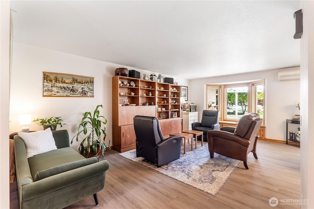 6888 Golf View Dr, Lynden, WA 98264 - living room featuring light wood-style floors, a wall unit AC, and baseboards
