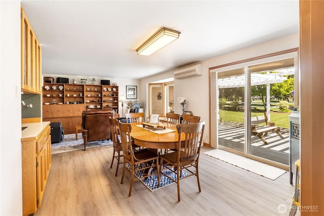 6888 Golf View Dr, Lynden, WA 98264 - dining room featuring a wall unit AC and light wood-style flooring