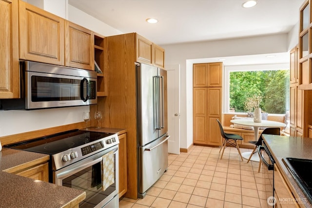 4828 38th Ave NE, Seattle, WA 98105 - kitchen featuring appliances with stainless steel finishes, light tile patterned flooring, dark countertops, recessed lighting, and open shelves
