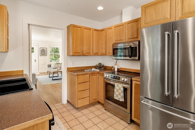 4828 38th Ave NE, Seattle, WA 98105 - kitchen with stainless steel appliances, recessed lighting, and light tile patterned flooring