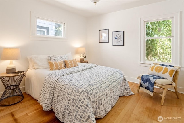 4828 38th Ave NE, Seattle, WA 98105 - bedroom featuring hardwood / wood-style floors, multiple windows, and baseboards