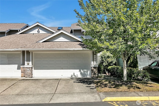 5909 Panorama Dr SE Unit 6-103, Auburn, WA 98092 - view of property with roof with shingles, stone siding, concrete driveway, and an attached garage
