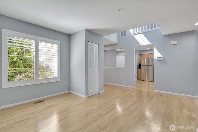 5909 Panorama Dr SE Unit 6-103, Auburn, WA 98092 - unfurnished living room featuring baseboards and light wood finished floors