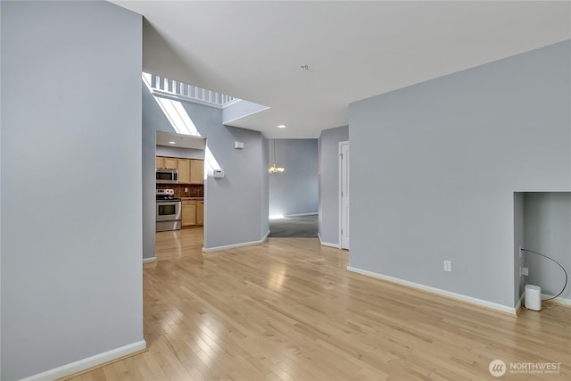 5909 Panorama Dr SE Unit 6-103, Auburn, WA 98092 - unfurnished living room with baseboards and light wood-type flooring