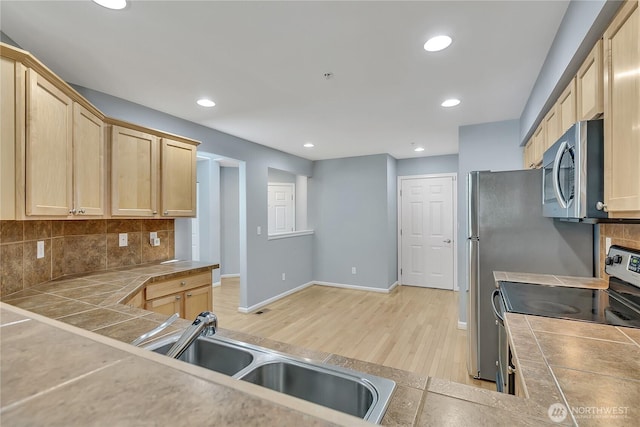 5909 Panorama Dr SE Unit 6-103, Auburn, WA 98092 - kitchen with appliances with stainless steel finishes, light wood finished floors, tasteful backsplash, tile countertops, and recessed lighting