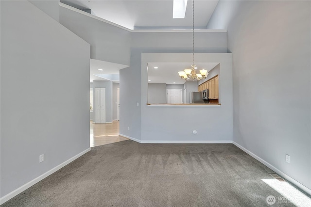 5909 Panorama Dr SE Unit 6-103, Auburn, WA 98092 - unfurnished living room with a chandelier, carpet flooring, baseboards, and a high ceiling