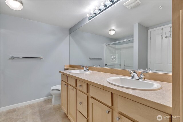5909 Panorama Dr SE Unit 6-103, Auburn, WA 98092 - bathroom with double vanity, a stall shower, toilet, and baseboards