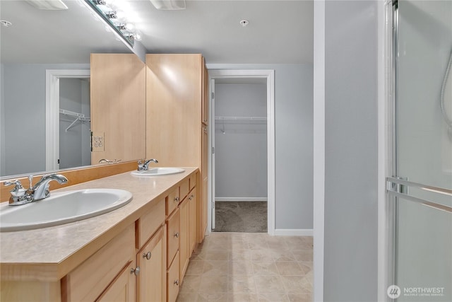 5909 Panorama Dr SE Unit 6-103, Auburn, WA 98092 - bathroom with double vanity, a walk in closet, and baseboards
