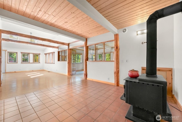 3542 Constitution Rd, Lummi Island, WA 98262 - unfurnished living room with a wood stove, wooden ceiling with exposed beams, baseboards, and tile patterned floors