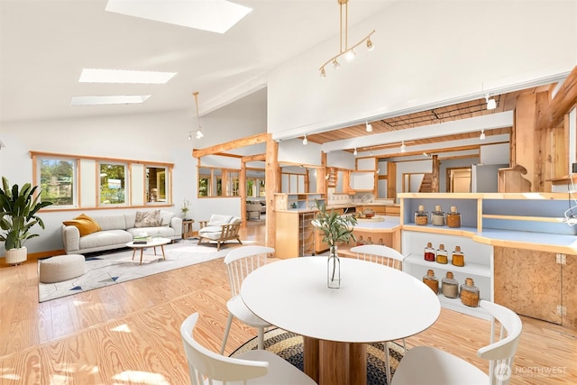 3542 Constitution Rd, Lummi Island, WA 98262 - dining area featuring a skylight, vaulted ceiling, and wood finished floors