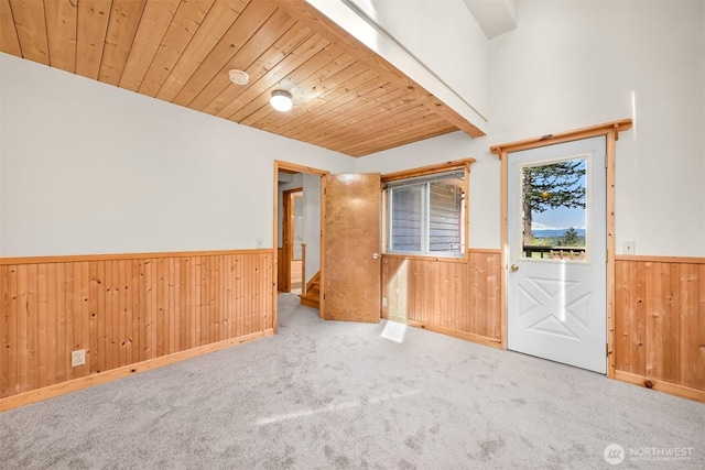 3542 Constitution Rd, Lummi Island, WA 98262 - carpeted empty room featuring a wainscoted wall, wood walls, wood ceiling, and stairs