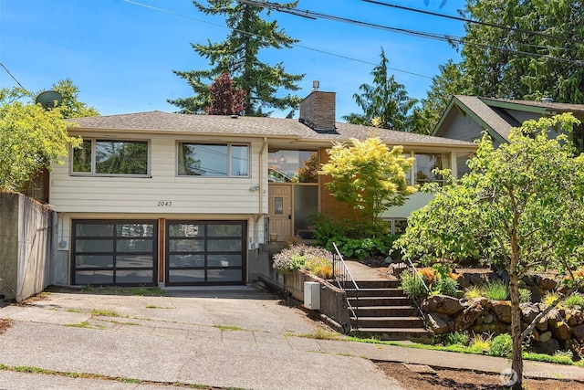 2043 N 78th St, Seattle, WA 98103 - view of front of property featuring a garage, a chimney, and driveway