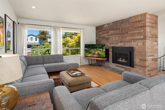 2043 N 78th St, Seattle, WA 98103 - living area featuring wood finished floors, a stone fireplace, and recessed lighting