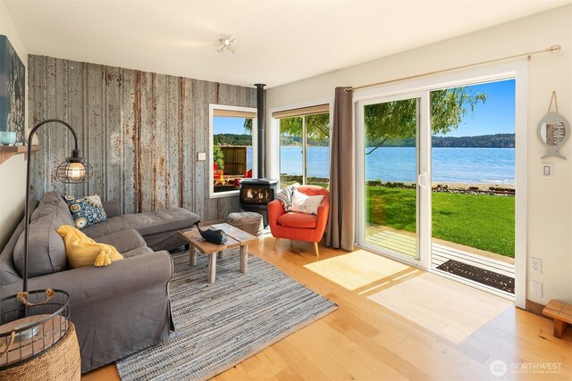 24410 Vashon Hwy SW, Vashon, WA 98070 - living room with a wood stove, wood finished floors, and a water view