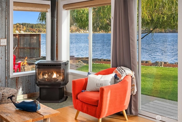 24410 Vashon Hwy SW, Vashon, WA 98070 - sitting room with a wood stove, a water view, and healthy amount of natural light