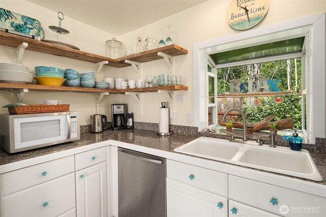 24410 Vashon Hwy SW, Vashon, WA 98070 - kitchen featuring white microwave, a sink, dishwasher, open shelves, and white cabinetry