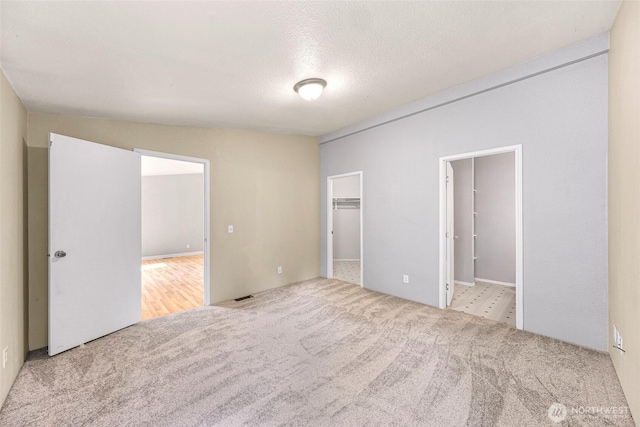 4949 Samish Way Unit 17, Bellingham, WA 98229 - unfurnished bedroom with carpet, a spacious closet, ensuite bath, and a textured ceiling