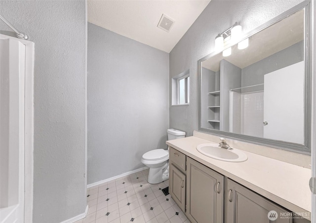 4949 Samish Way Unit 17, Bellingham, WA 98229 - bathroom with toilet, a shower, vanity, a textured wall, and baseboards