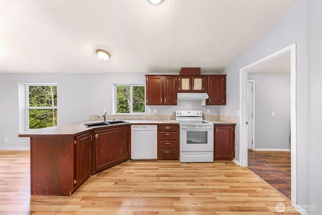 4949 Samish Way Unit 17, Bellingham, WA 98229 - kitchen with white appliances, a sink, a peninsula, light wood-type flooring, and a textured ceiling