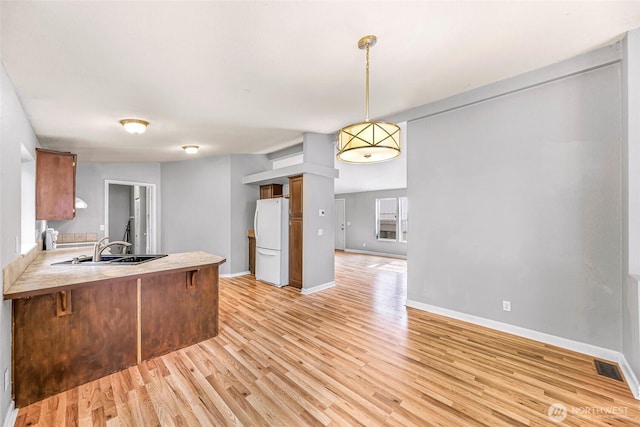 4949 Samish Way Unit 17, Bellingham, WA 98229 - kitchen featuring freestanding refrigerator, a sink, and light wood-style floors
