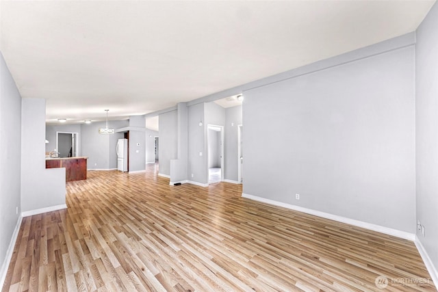 4949 Samish Way Unit 17, Bellingham, WA 98229 - unfurnished living room with light wood-style flooring and baseboards
