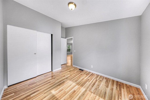 4949 Samish Way Unit 17, Bellingham, WA 98229 - unfurnished bedroom featuring light wood-style flooring, baseboards, and a closet