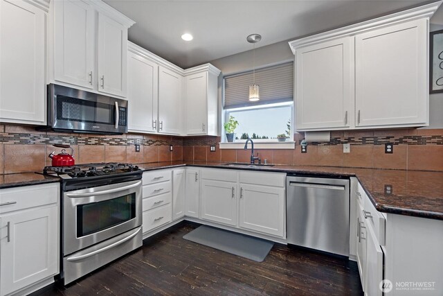 22306 137th Ave E, Graham, WA 98338 - kitchen featuring appliances with stainless steel finishes, a sink, dark wood-style flooring, white cabinets, and recessed lighting