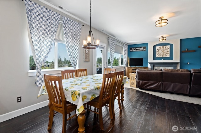 22306 137th Ave E, Graham, WA 98338 - dining space featuring dark wood-type flooring, baseboards, and a chandelier