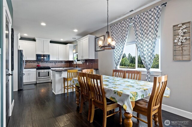 22306 137th Ave E, Graham, WA 98338 - dining area featuring dark wood finished floors, baseboards, recessed lighting, and a chandelier