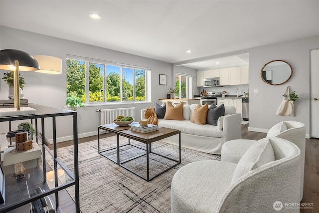 1800 Taylor Ave N Unit 1, Seattle, WA 98109 - living room featuring wood finished floors, baseboards, radiator heating unit, and recessed lighting