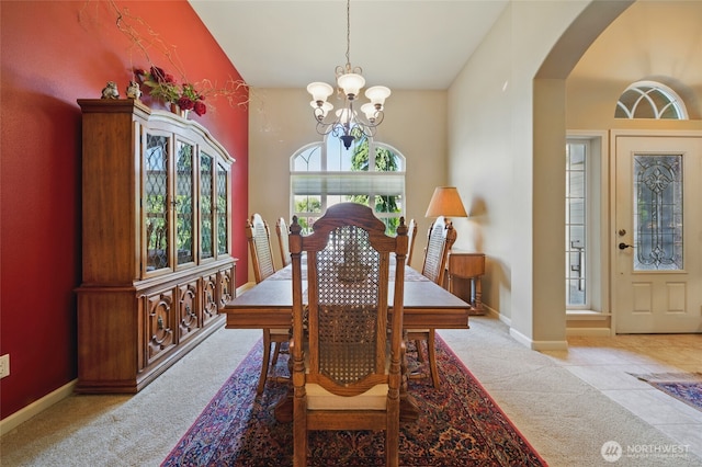 832 SE Vintage Way, College Place, WA 99324 - dining area featuring a chandelier, arched walkways, carpet floors, baseboards, and vaulted ceiling