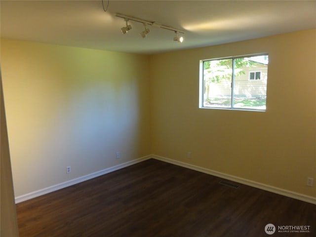 1242 Lidstrom Rd E, Port Orchard, WA 98366 - unfurnished room with rail lighting, dark wood-style flooring, and baseboards