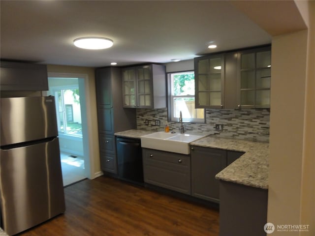 1242 Lidstrom Rd E, Port Orchard, WA 98366 - kitchen with freestanding refrigerator, dishwashing machine, a sink, tasteful backsplash, and dark wood-style floors