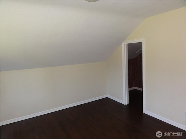 1242 Lidstrom Rd E, Port Orchard, WA 98366 - additional living space featuring vaulted ceiling, dark wood-type flooring, and baseboards