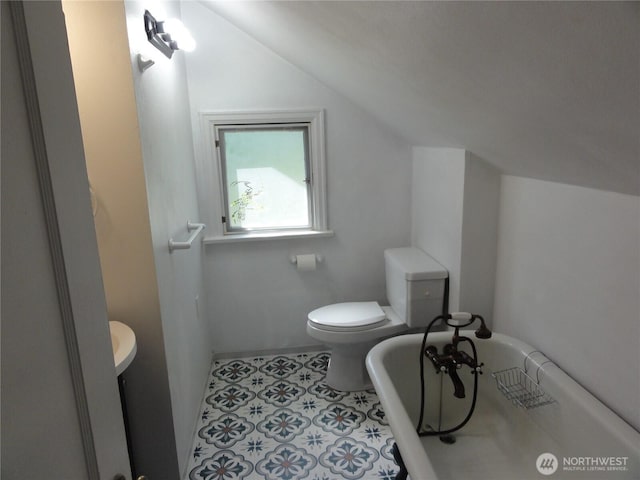 1242 Lidstrom Rd E, Port Orchard, WA 98366 - bathroom featuring a tub to relax in, toilet, and vaulted ceiling