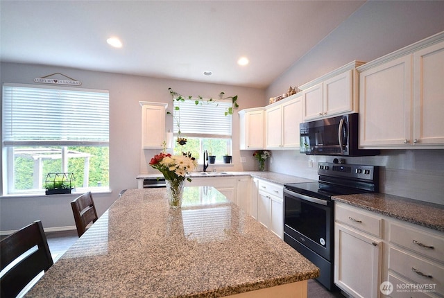 15437 104th Way SE, Yelm, WA 98597 - kitchen featuring black range with electric stovetop, white cabinetry, decorative backsplash, light stone counters, and recessed lighting