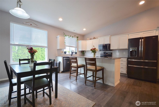 15437 104th Way SE, Yelm, WA 98597 - kitchen featuring stainless steel appliances, a kitchen island, decorative backsplash, white cabinets, and recessed lighting