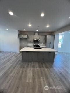 12080 127th Avenue Ct E Unit 73, Puyallup, WA 98374 - kitchen featuring stainless steel appliances, gray cabinetry, wood finished floors, a large island, and recessed lighting