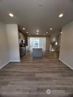 12080 127th Avenue Ct E Unit 73, Puyallup, WA 98374 - kitchen featuring baseboards, dark wood-style flooring, recessed lighting, an island with sink, and open floor plan