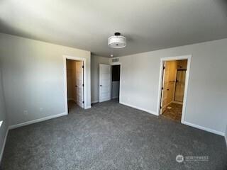 12080 127th Avenue Ct E Unit 73, Puyallup, WA 98374 - unfurnished bedroom featuring baseboards, carpet flooring, and a closet