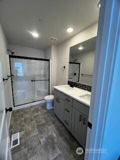 12080 127th Avenue Ct E Unit 73, Puyallup, WA 98374 - bathroom featuring double vanity, a stall shower, and toilet