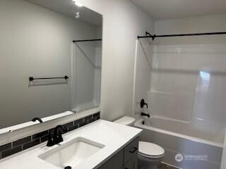 12080 127th Avenue Ct E Unit 73, Puyallup, WA 98374 - bathroom featuring toilet, vanity, and shower / bathtub combination
