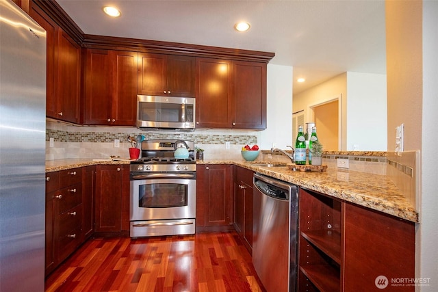220 1st St Unit 409, Kirkland, WA 98033 - kitchen with appliances with stainless steel finishes, dark wood-style floors, a sink, backsplash, and recessed lighting