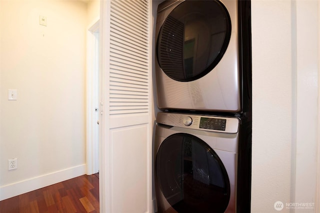 220 1st St Unit 409, Kirkland, WA 98033 - laundry room with stacked washer and clothes dryer, dark wood-style floors, and baseboards