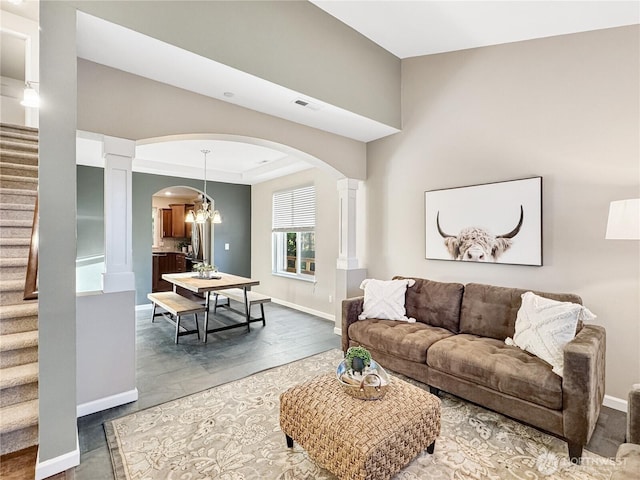 4339 S 160th St, Tukwila, WA 98188 - living room featuring arched walkways, ornate columns, and stairway