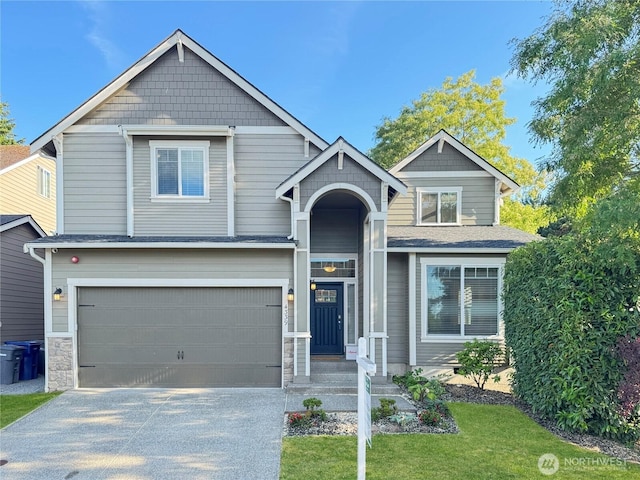 4339 S 160th St, Tukwila, WA 98188 - craftsman-style home featuring an attached garage, driveway, stone siding, and a front lawn