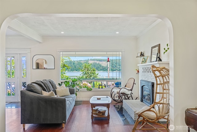 5060 E State Route 106, Union, WA 98592 - living room featuring healthy amount of natural light, hardwood / wood-style floors, crown molding, arched walkways, and a fireplace
